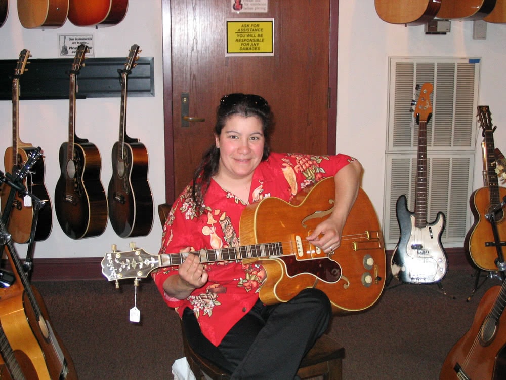 Alicia plays a lefty Epiphone Tenor Guitar at Gruhn's